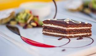 Feines Dessert mit Schokoladencreme und Früchten auf weißem Teller – Genussmoment im Wellnesshotel The Breakers am Roten Meer